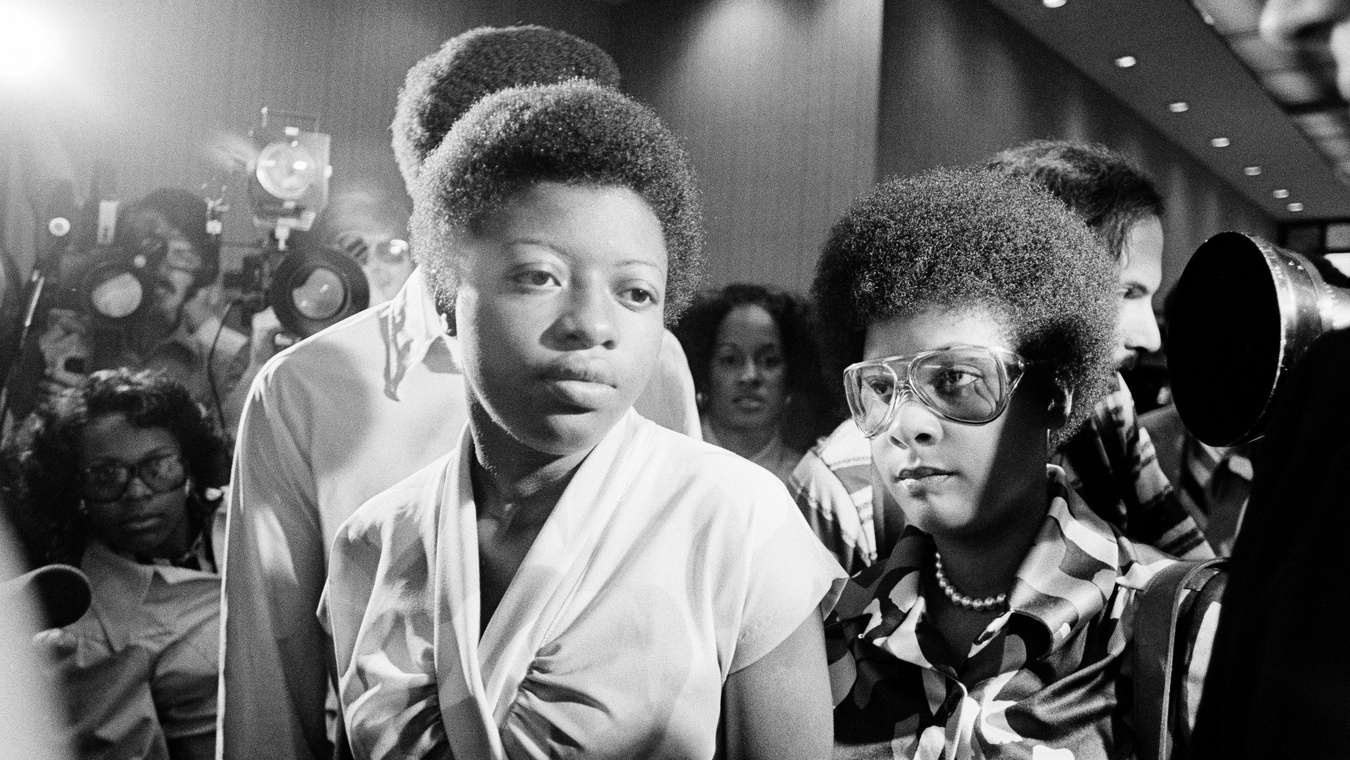 Joan Little surrounded by reporters